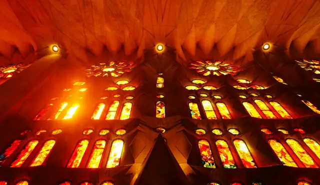 Sunlight streaming through the colourful stained glass windows of the Sagrada Família