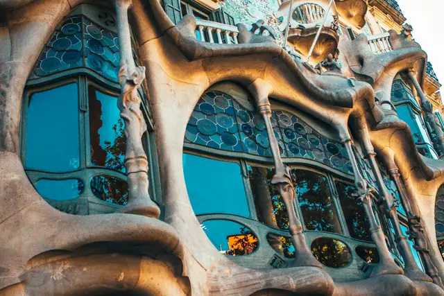 The towers of the Sagrada Família seen through ornamental iron gates
