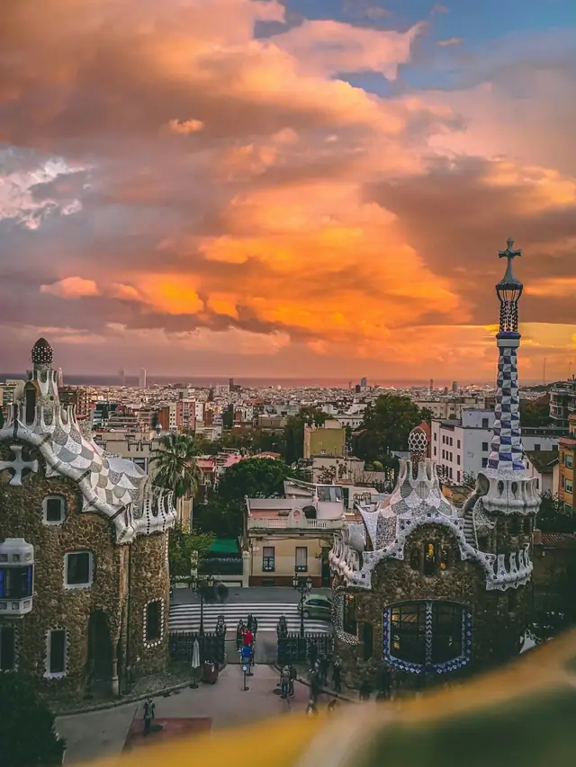 The Sagrada Família at golden hour, glowing against an orange sunset sky